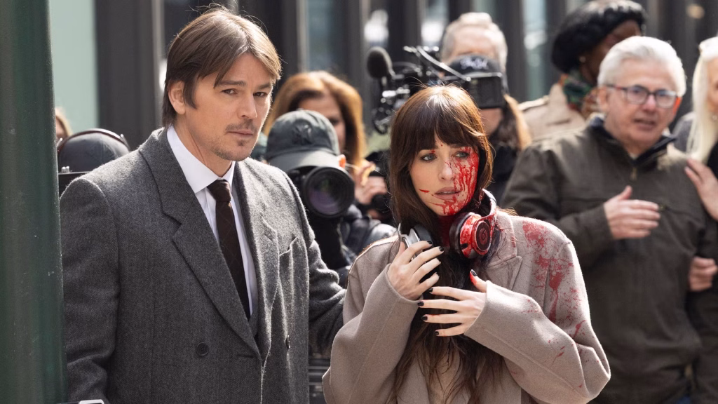 Still from 'Verity', starring Anne Hathaway as Verity Crawford, with Dakota Johnson as Lowen Ashleigh and Josh Hartnett as Jeremy Crawford.
When Is ‘Verity’ Streaming On Prime Video? How To Watch In The US And UK